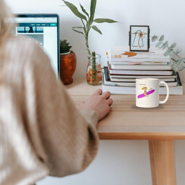 woman working in a desk with a surf coffee mug